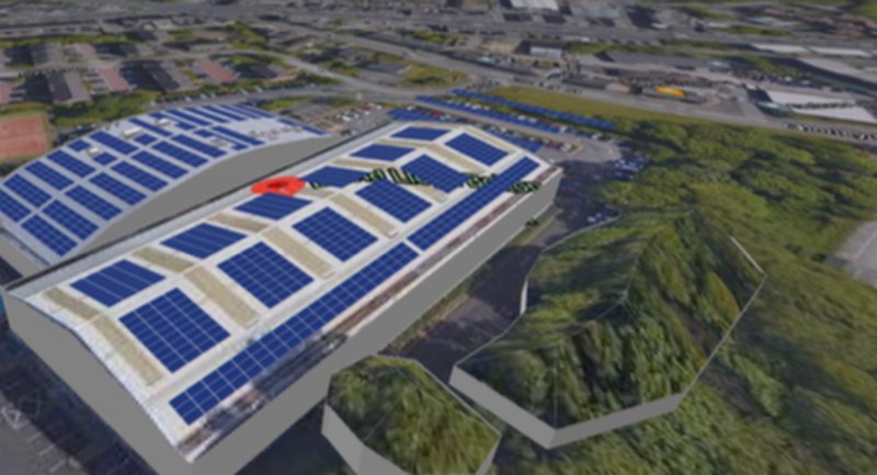 3D model of a large commercial building with solar panels across several roof sections